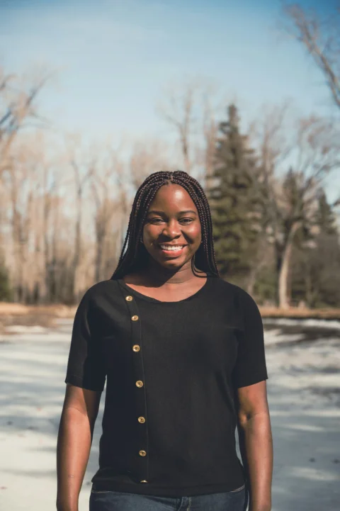 woman in black shirt standing on snow covered ground during daytime