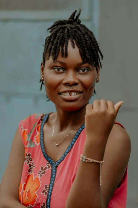Smiling woman gives a thumbs-up gesture