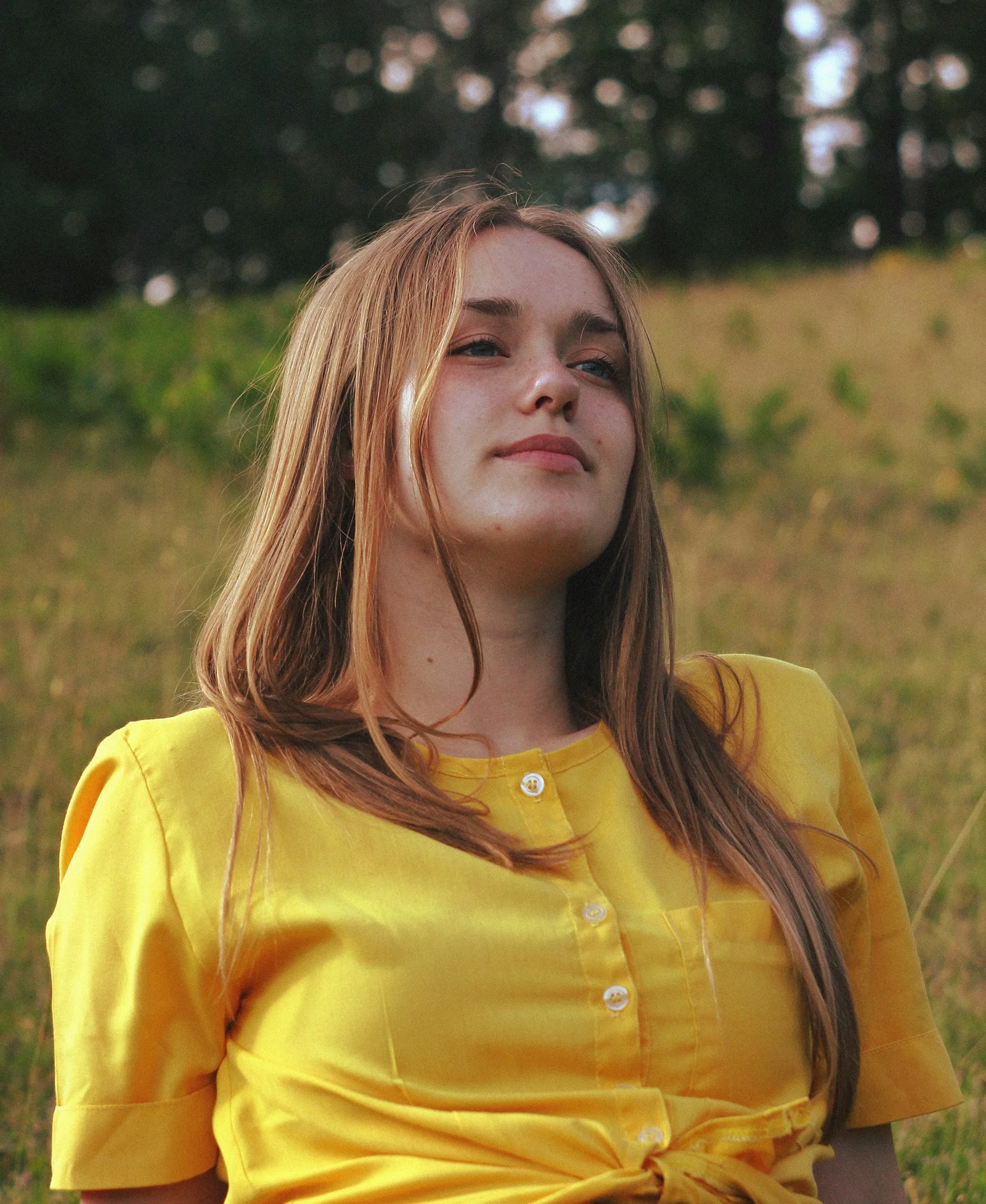 Young woman in yellow shirt outdoors