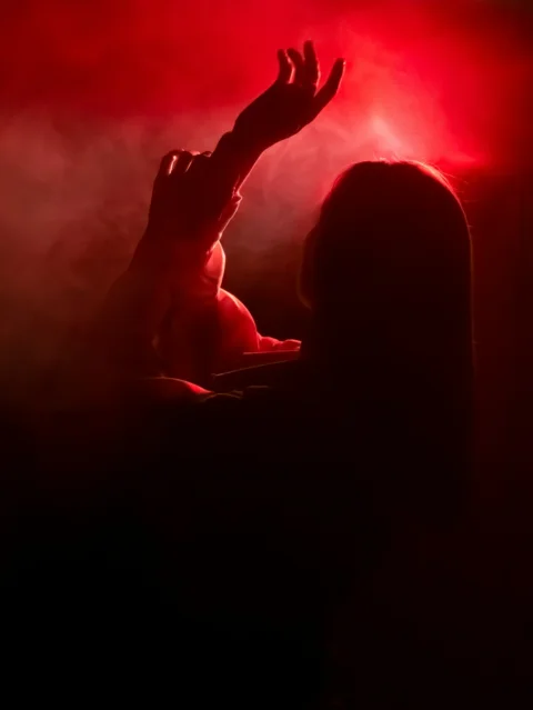 a person raising their hands in the air
