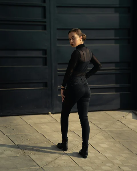 A woman standing in front of a garage door