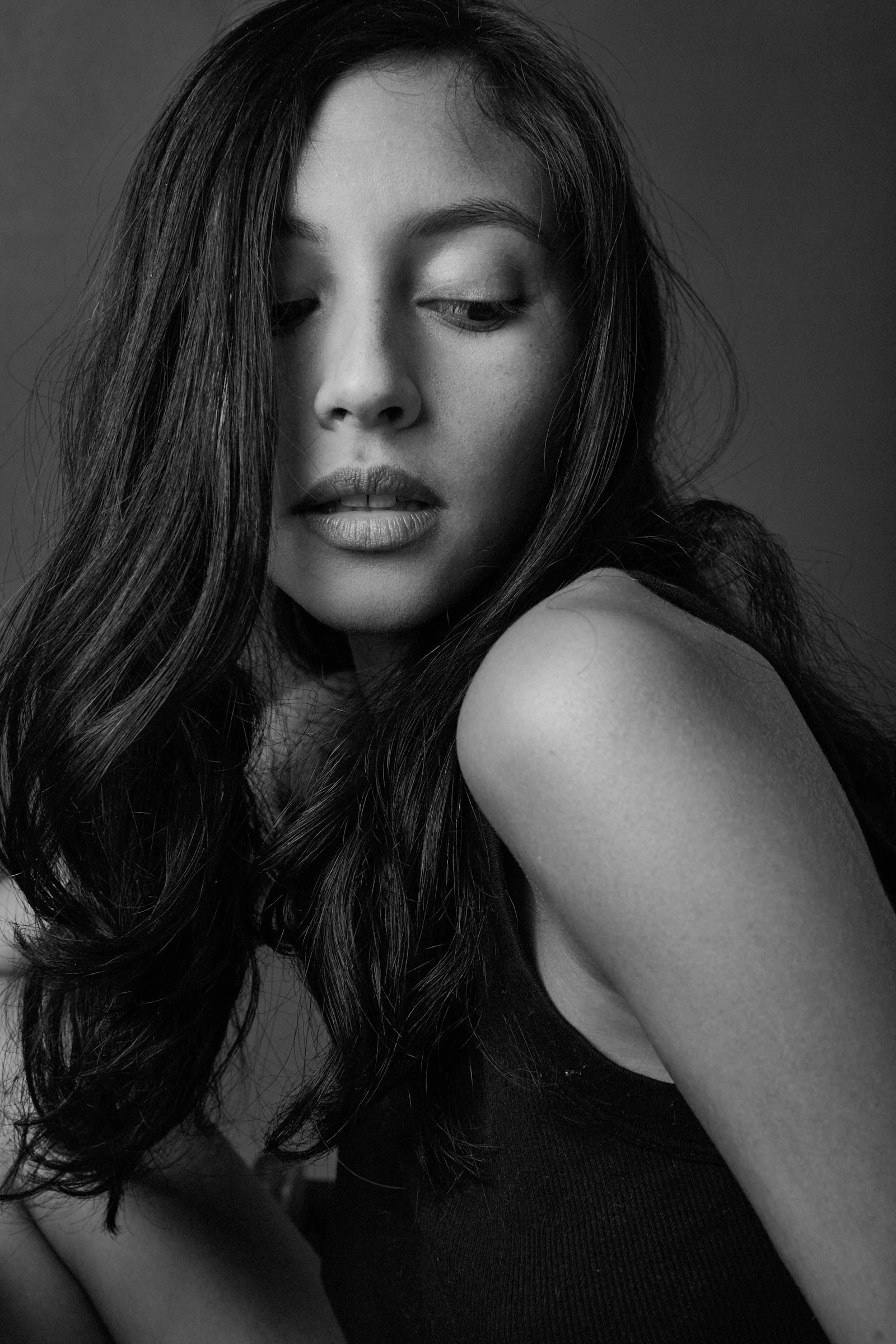 a black and white photo of a woman with her eyes closed