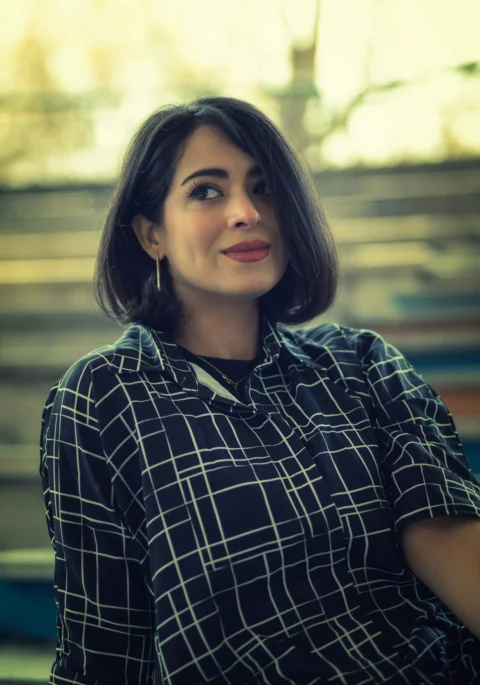 a woman with short hair wearing a black and white shirt