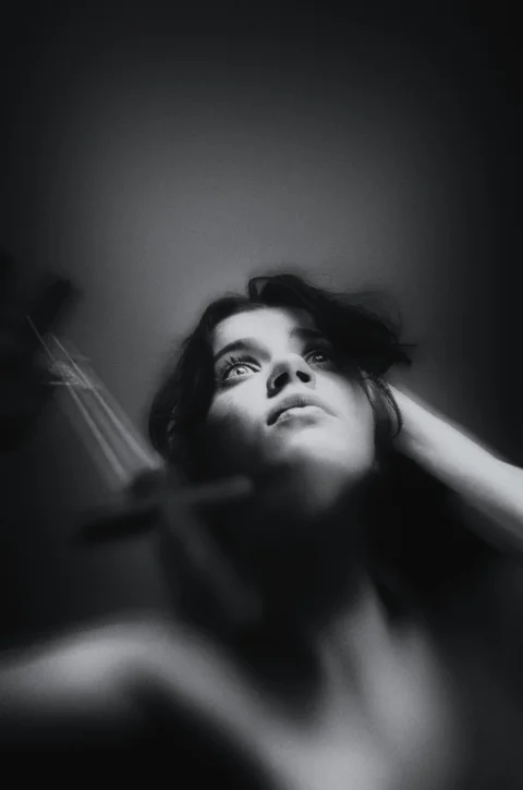a black and white photo of a woman brushing her hair