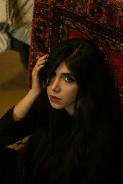 Young woman with dark hair looking at the camera