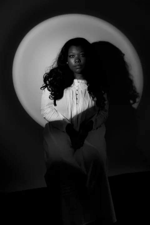 Woman sitting in front of a large circle