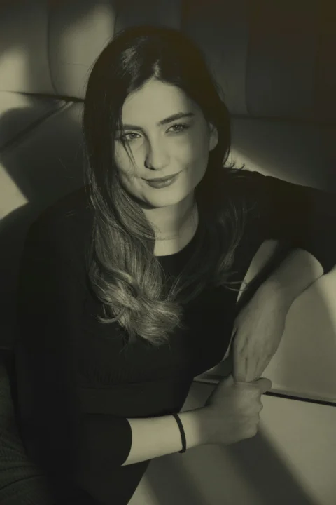 a black and white photo of a woman sitting on a couch
