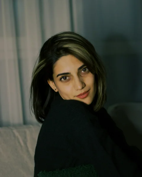 A woman sitting on top of a white couch