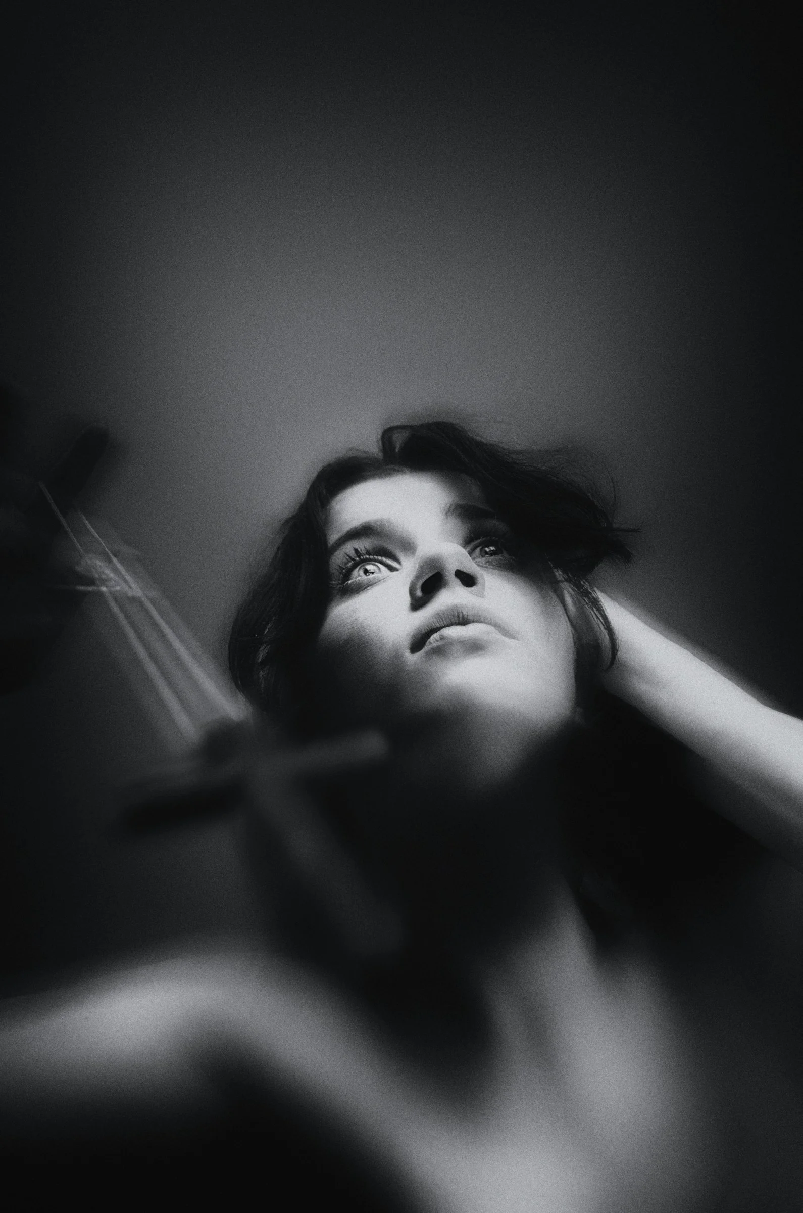 a black and white photo of a woman brushing her hair