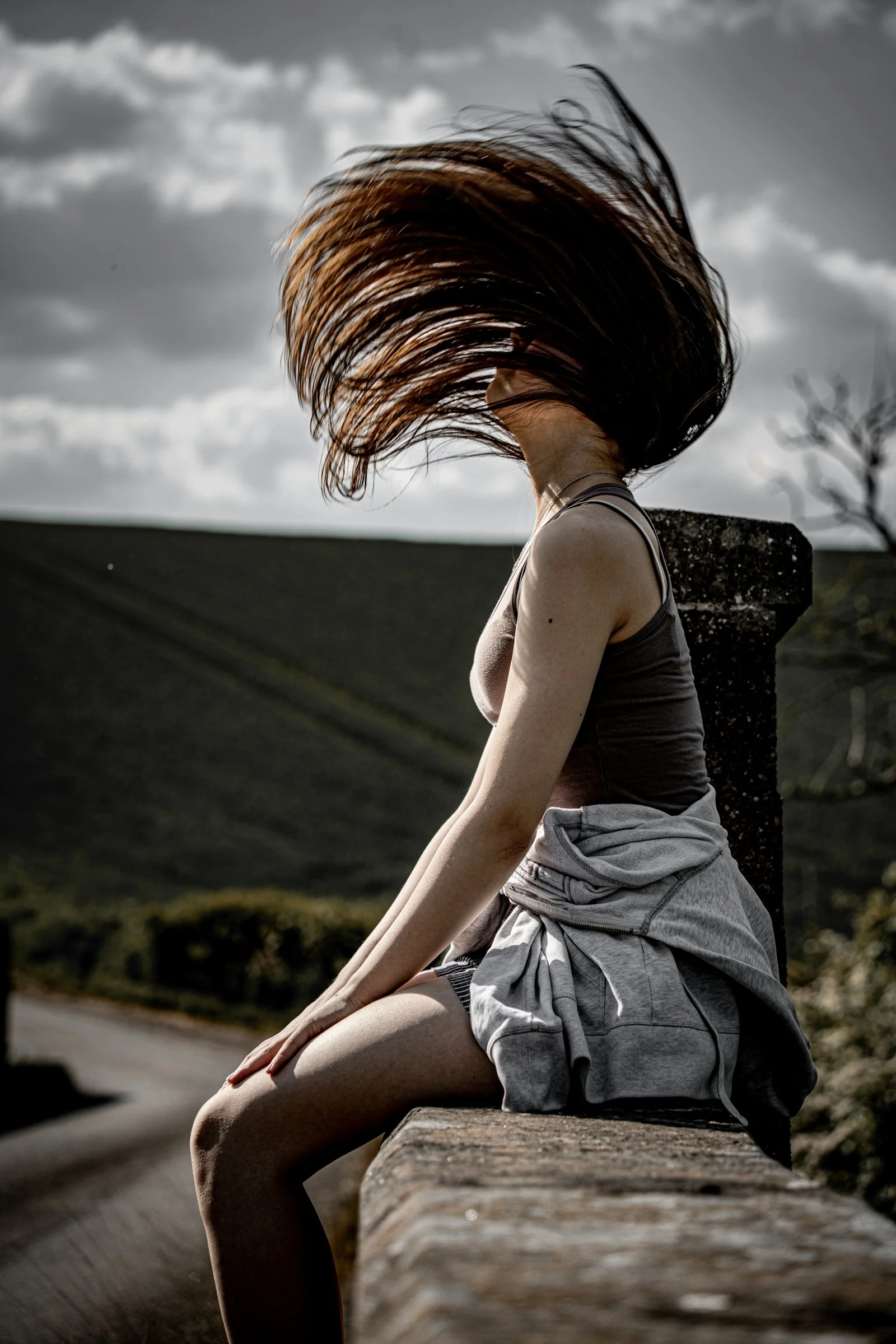 Woman with long hair flipping outdoors