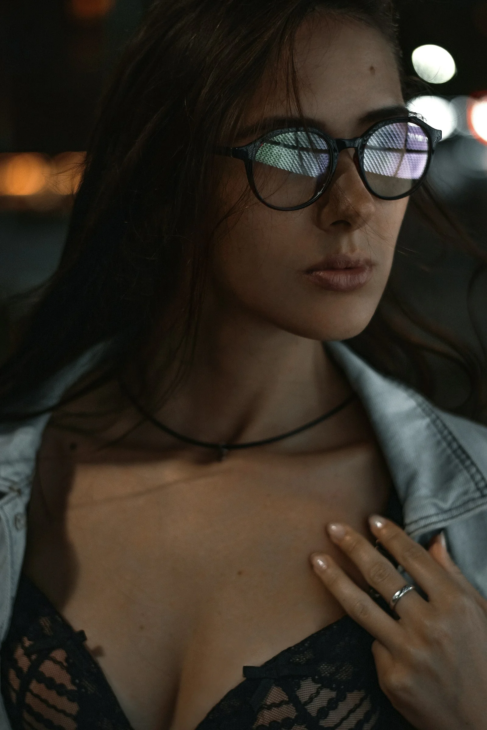 a woman wearing glasses and a jacket