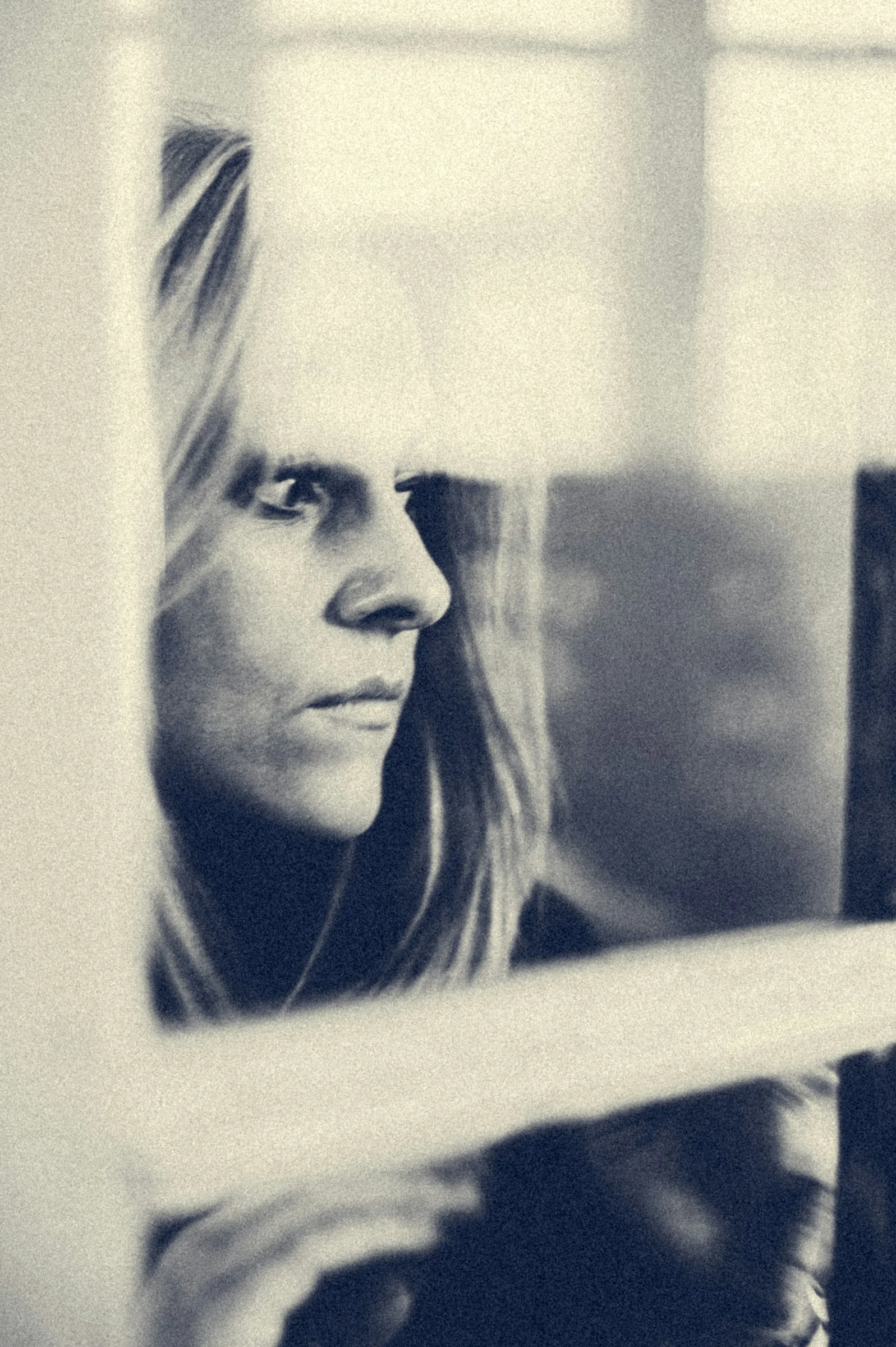 woman in black shirt looking at the window