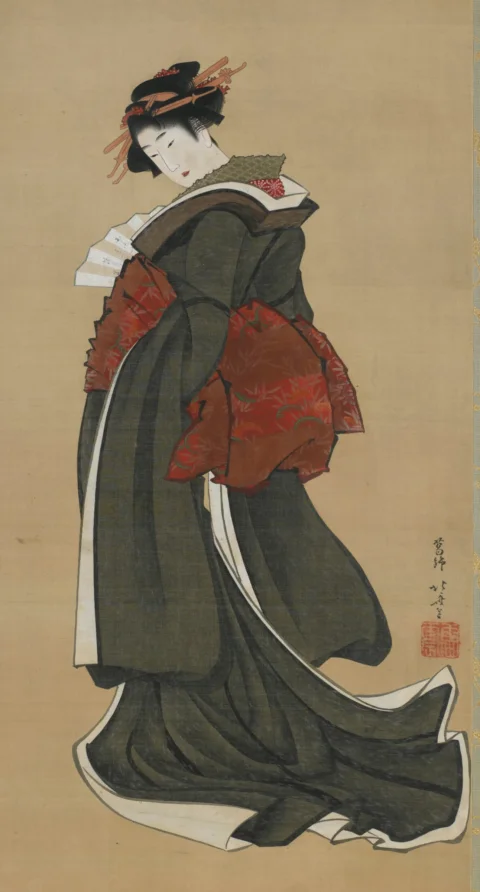 A japanese woman in a black kimono holds a fan