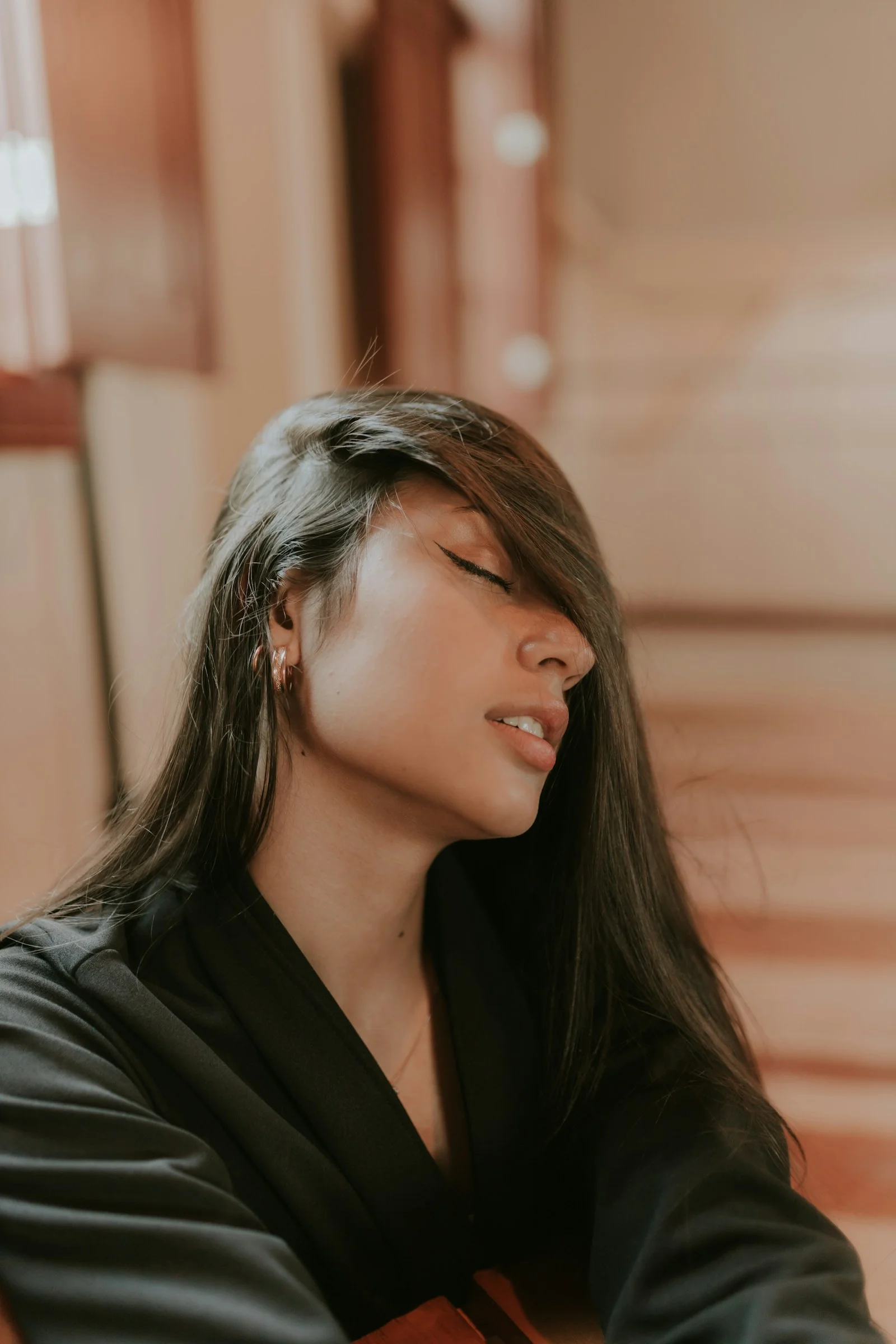 A woman with long hair is playing a guitar