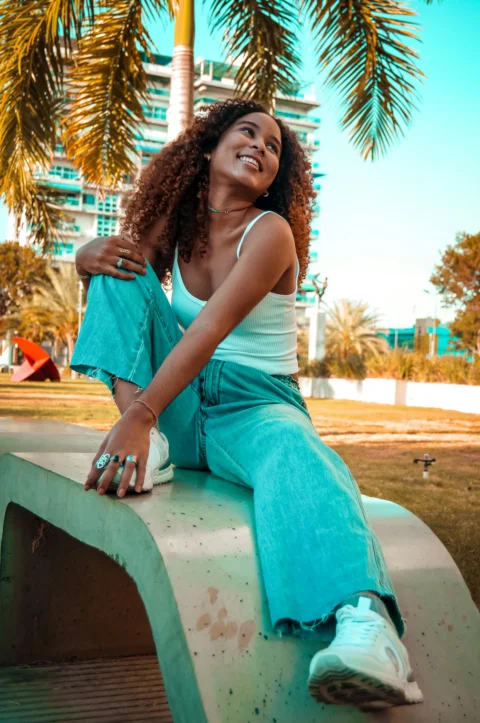 a woman sitting on a bench in a park