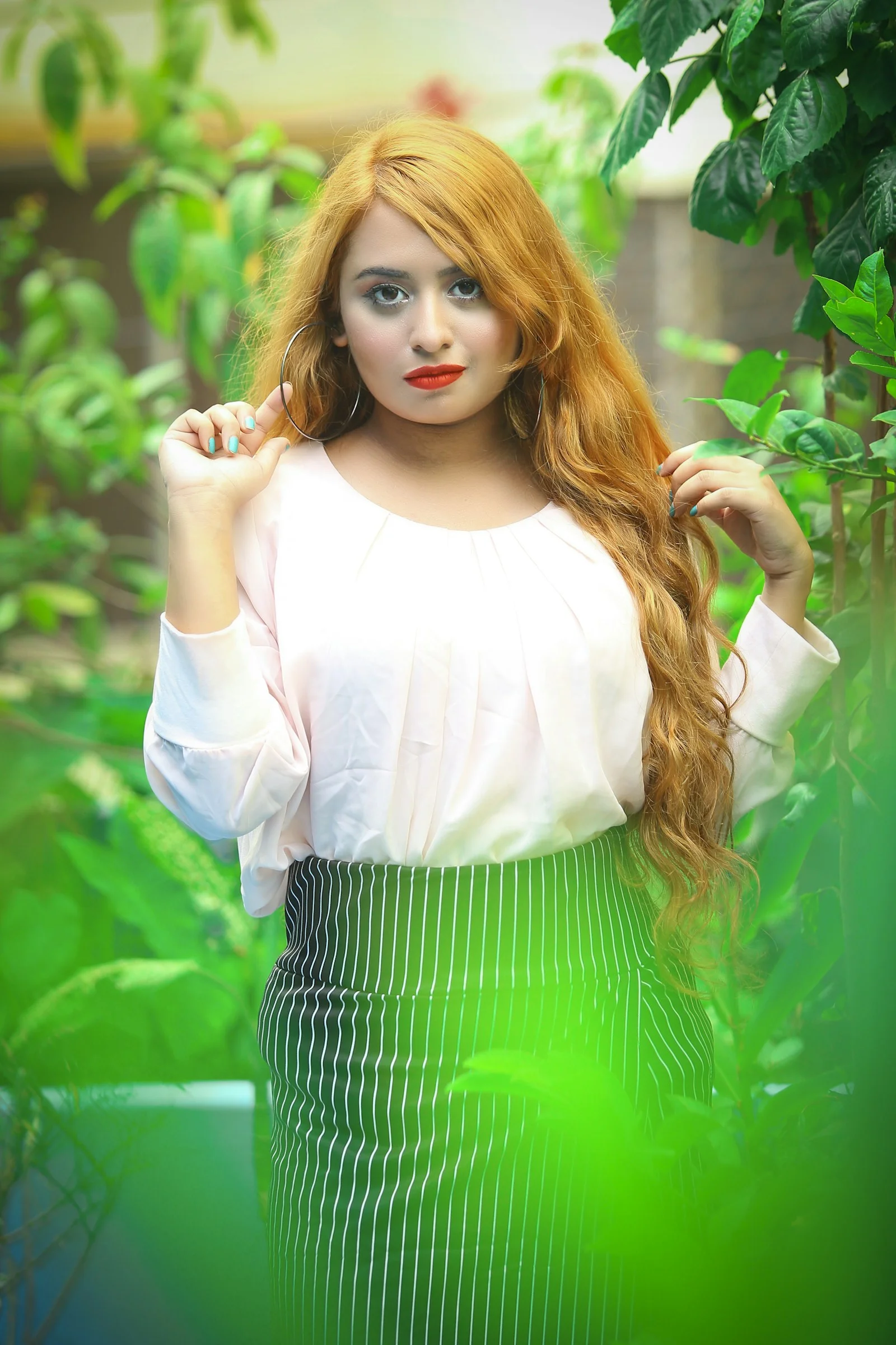 a woman with long red hair posing for a picture