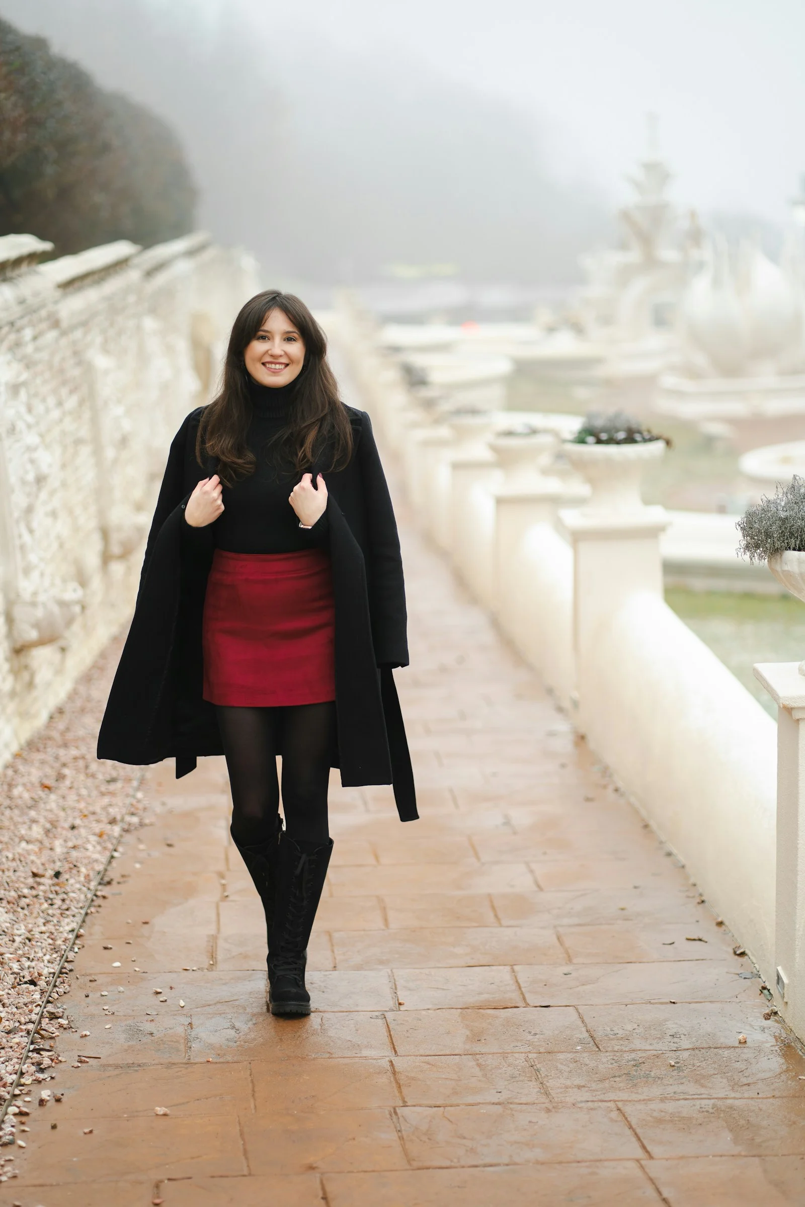 A woman in a red dress is walking down a path