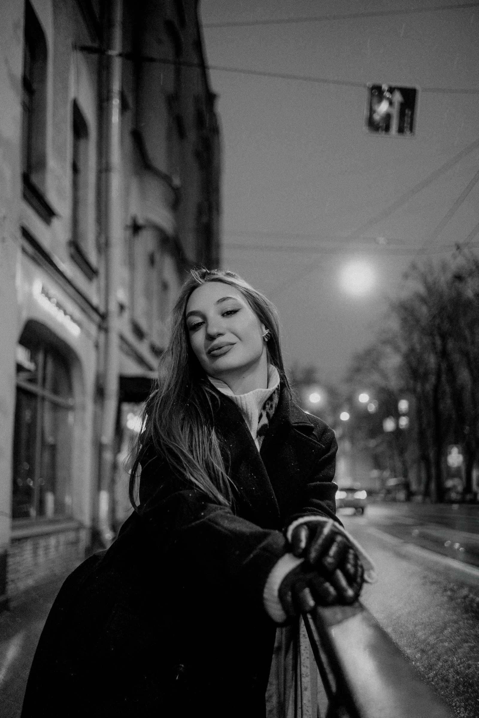 A woman in a coat and gloves on a city street