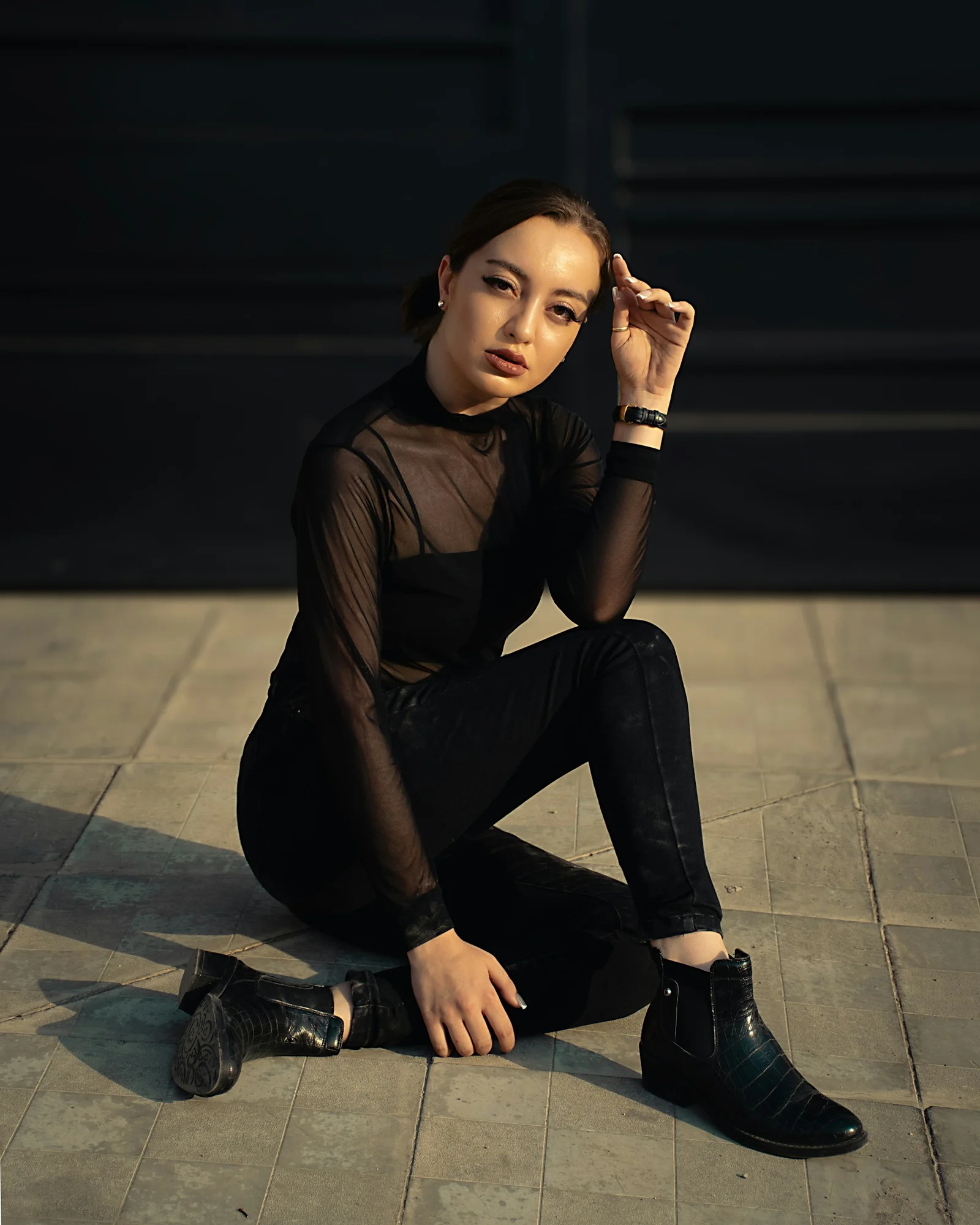 A woman sitting on the ground with her legs crossed