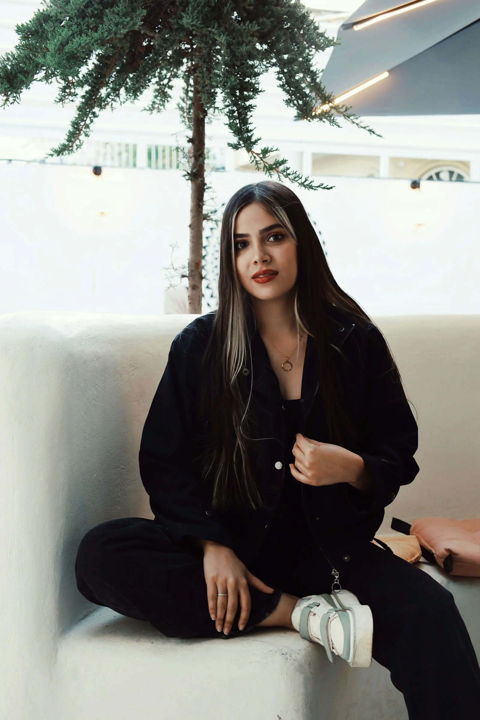 A woman sitting on top of a white couch