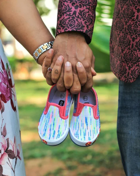 A close up of two people holding hands