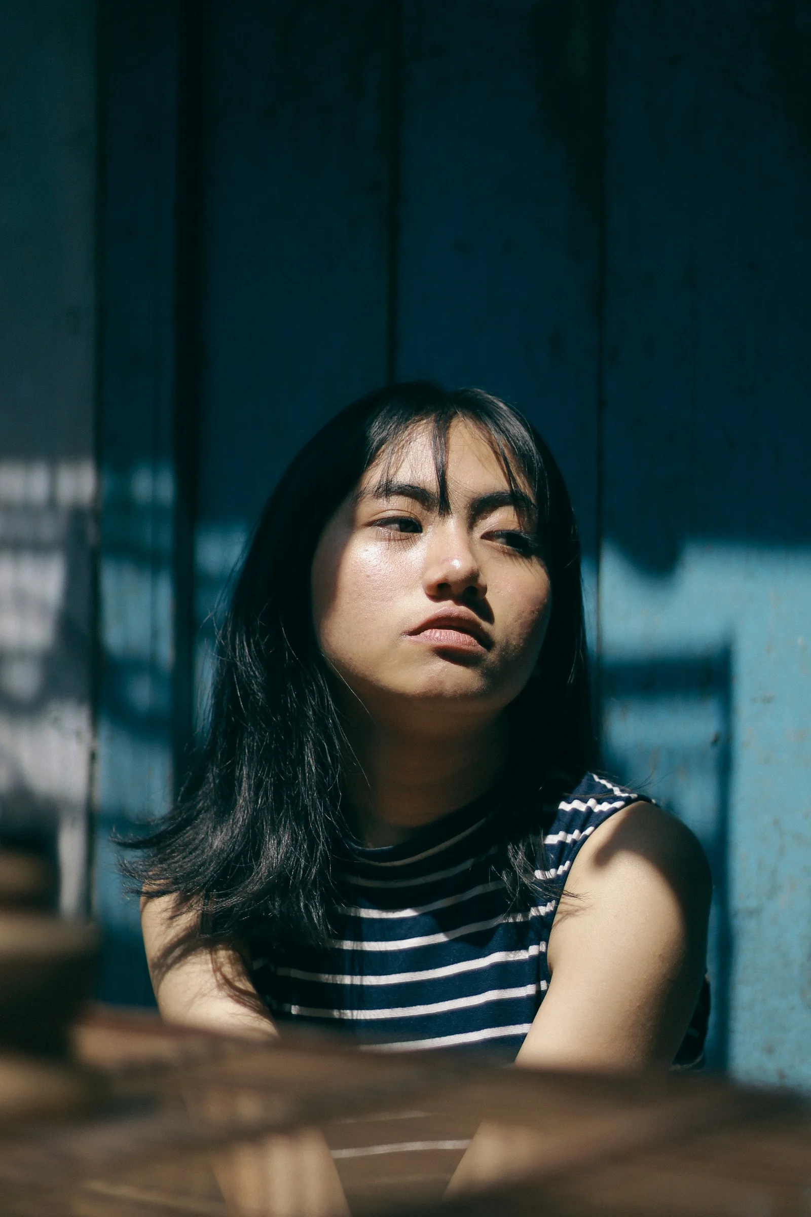 a woman sitting down with her eyes closed