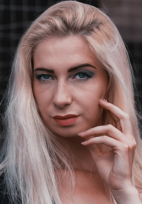 a woman with long blonde hair and blue eyes