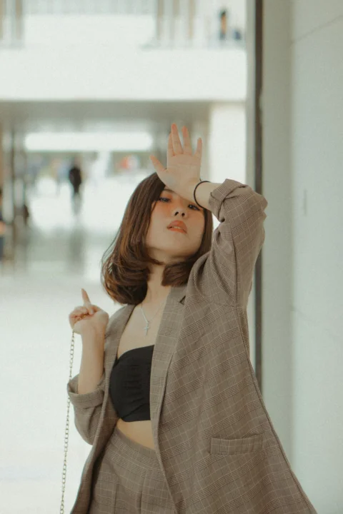 woman placing left hand on forehead