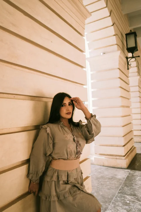 A woman poses in a stylish outfit