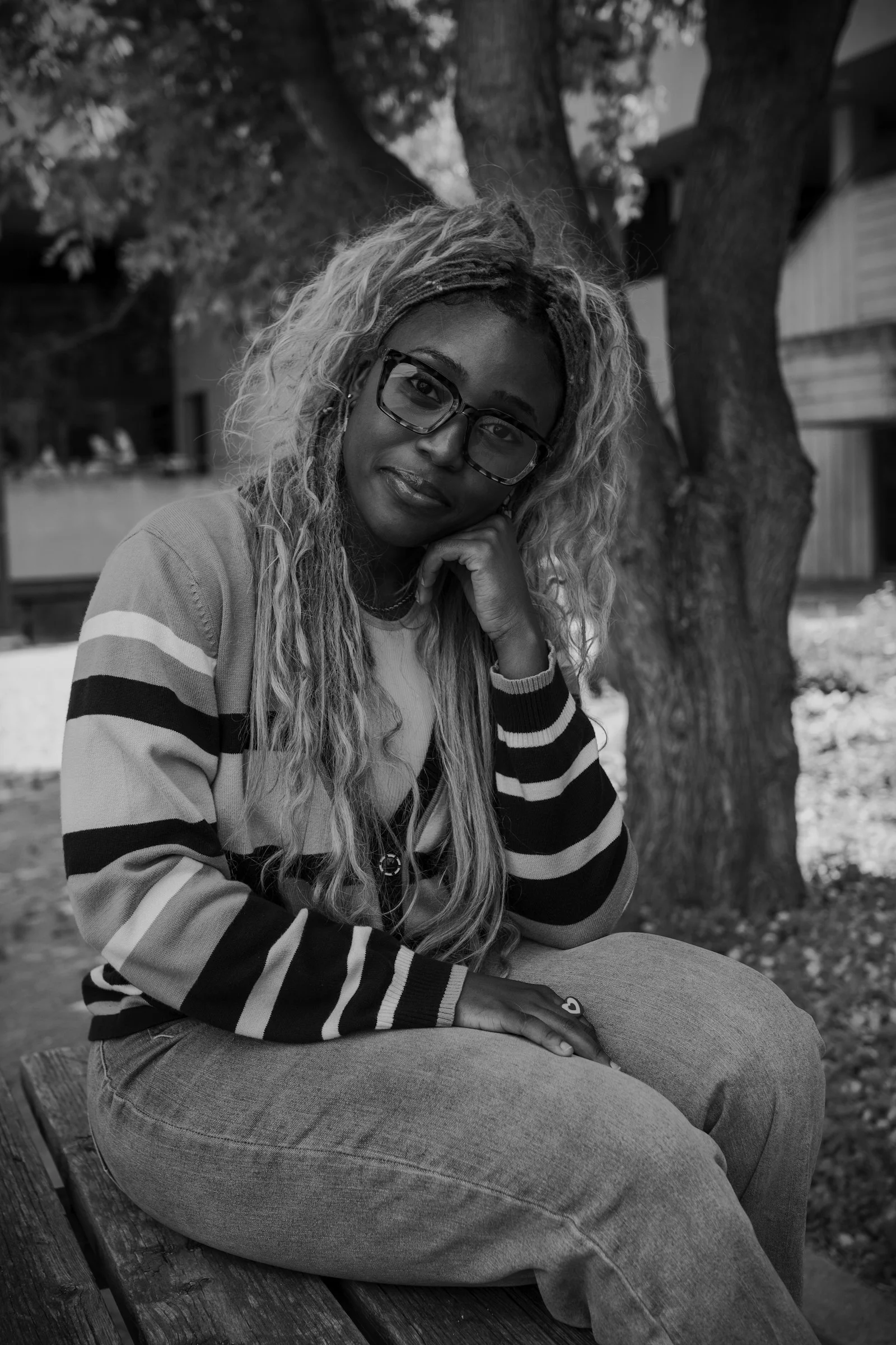 A woman in glasses poses for the camera