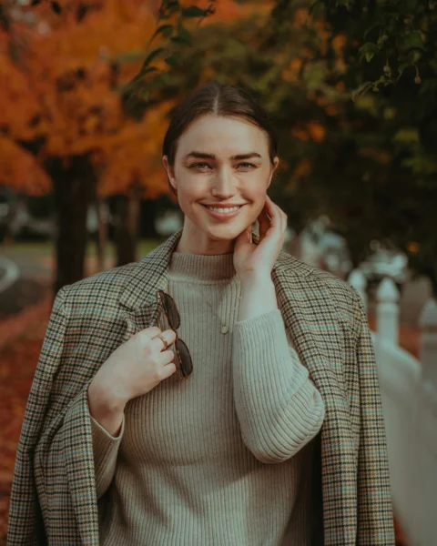 a person smiling while holding a phone