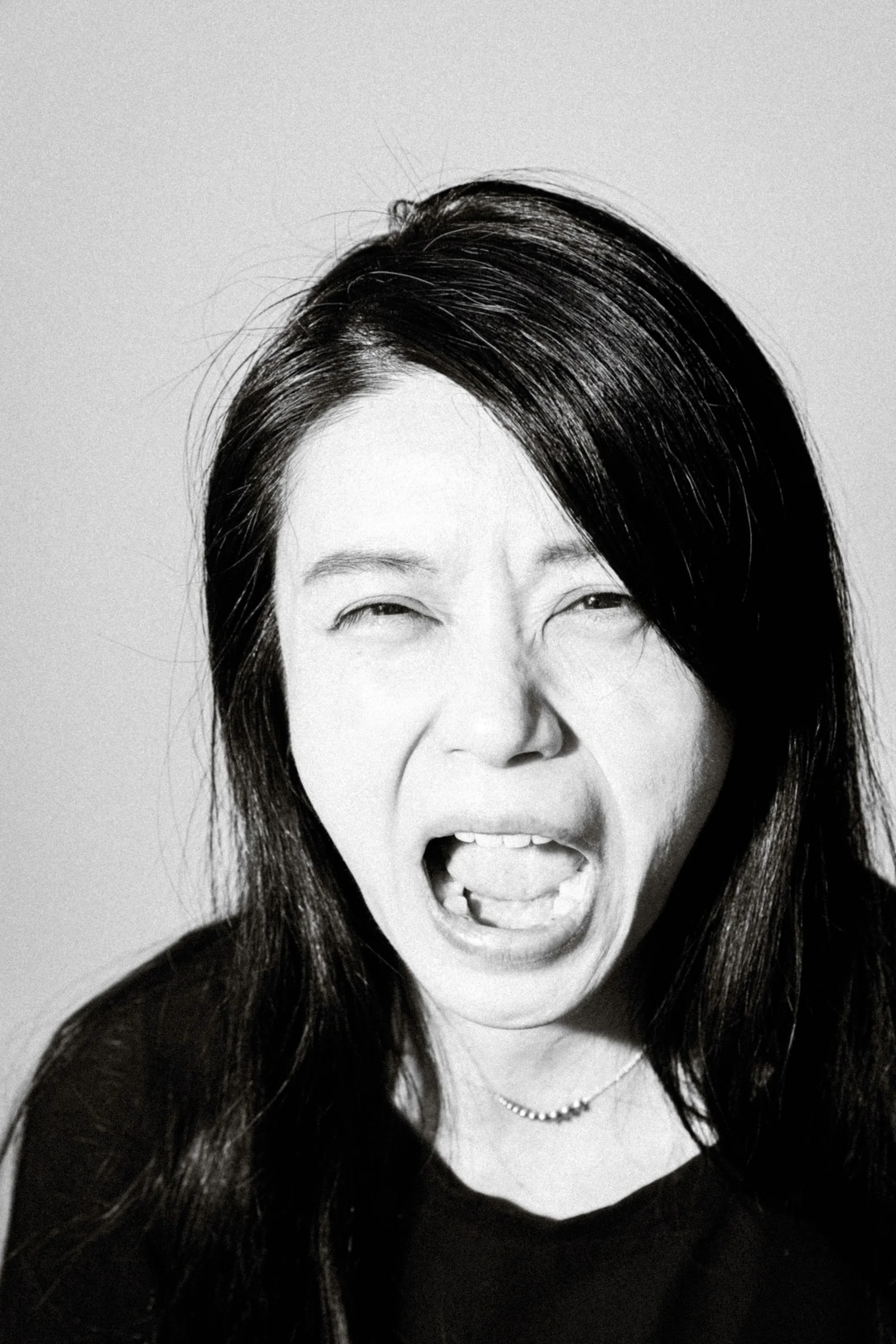 a woman making a face with her mouth open