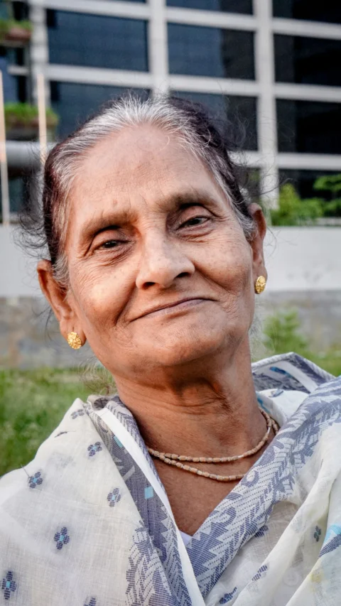 An older woman smiles at the camera
