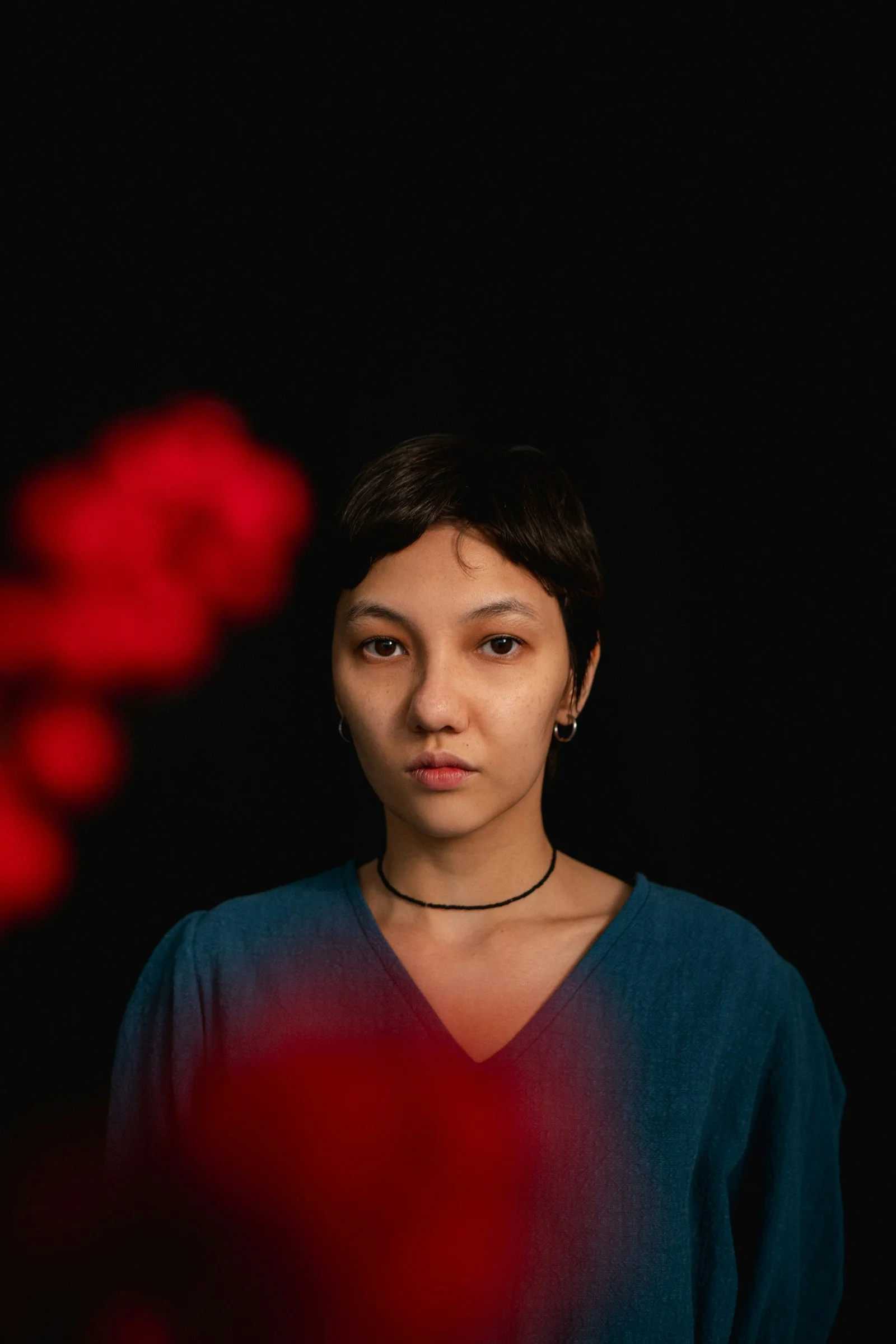 a woman standing in front of a black background