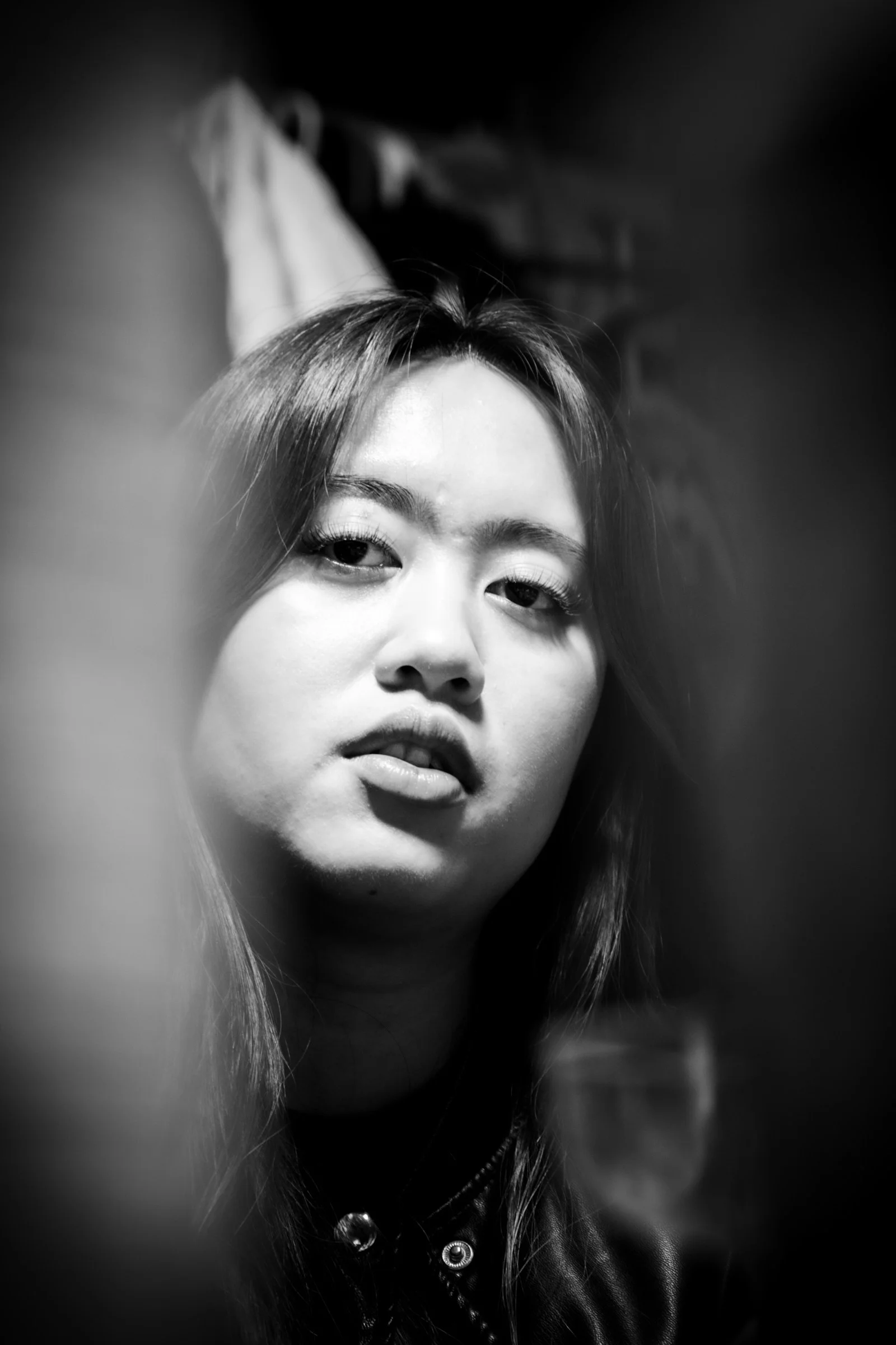 A woman stares intently in a black and white photo