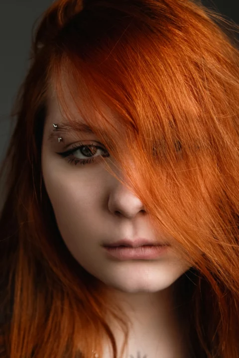 A close up of a woman with red hair