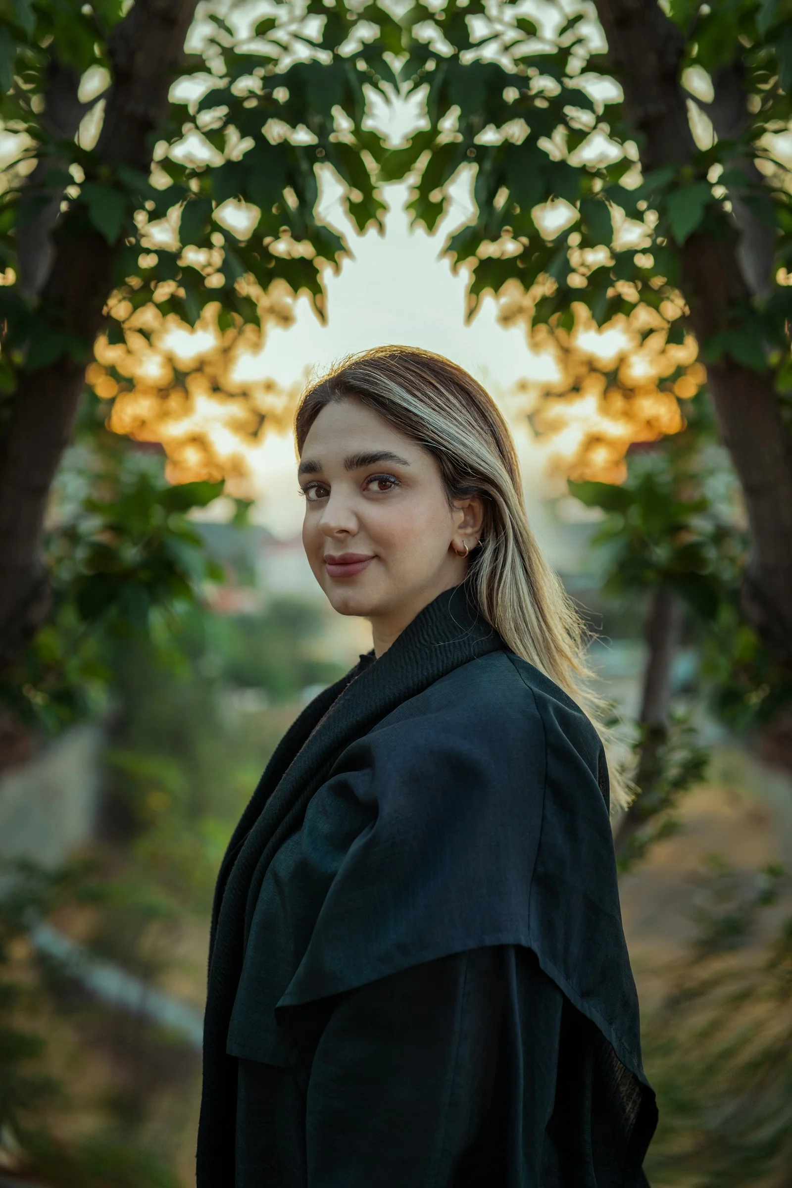 Woman with blonde hair in dark coat outdoors