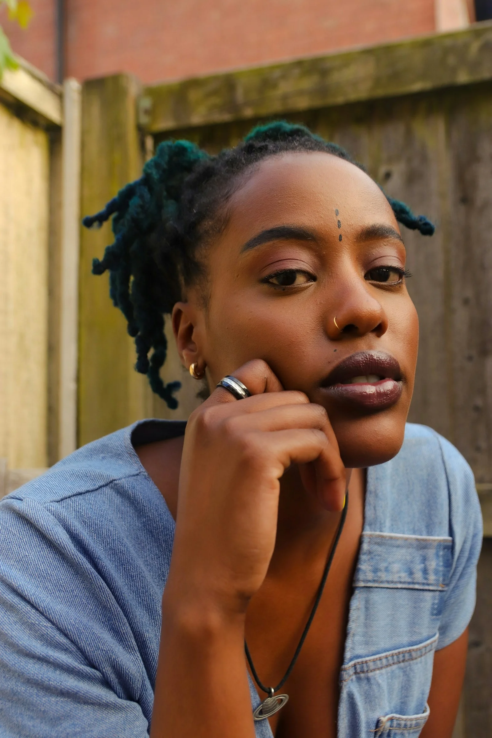 woman in gray shirt with blue hair