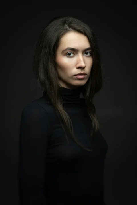 a woman with long hair and a black shirt