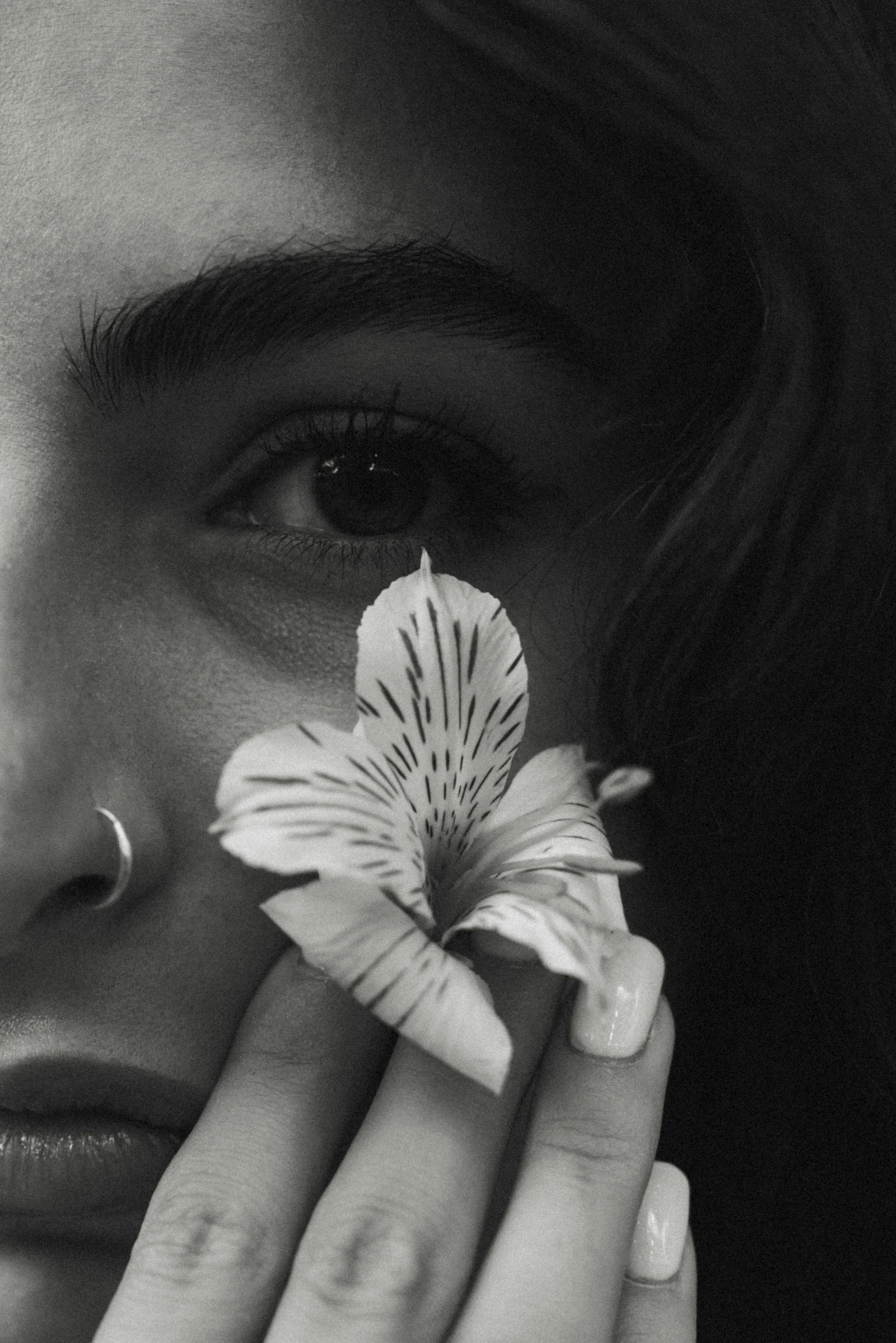 Woman holding a flower near her eye