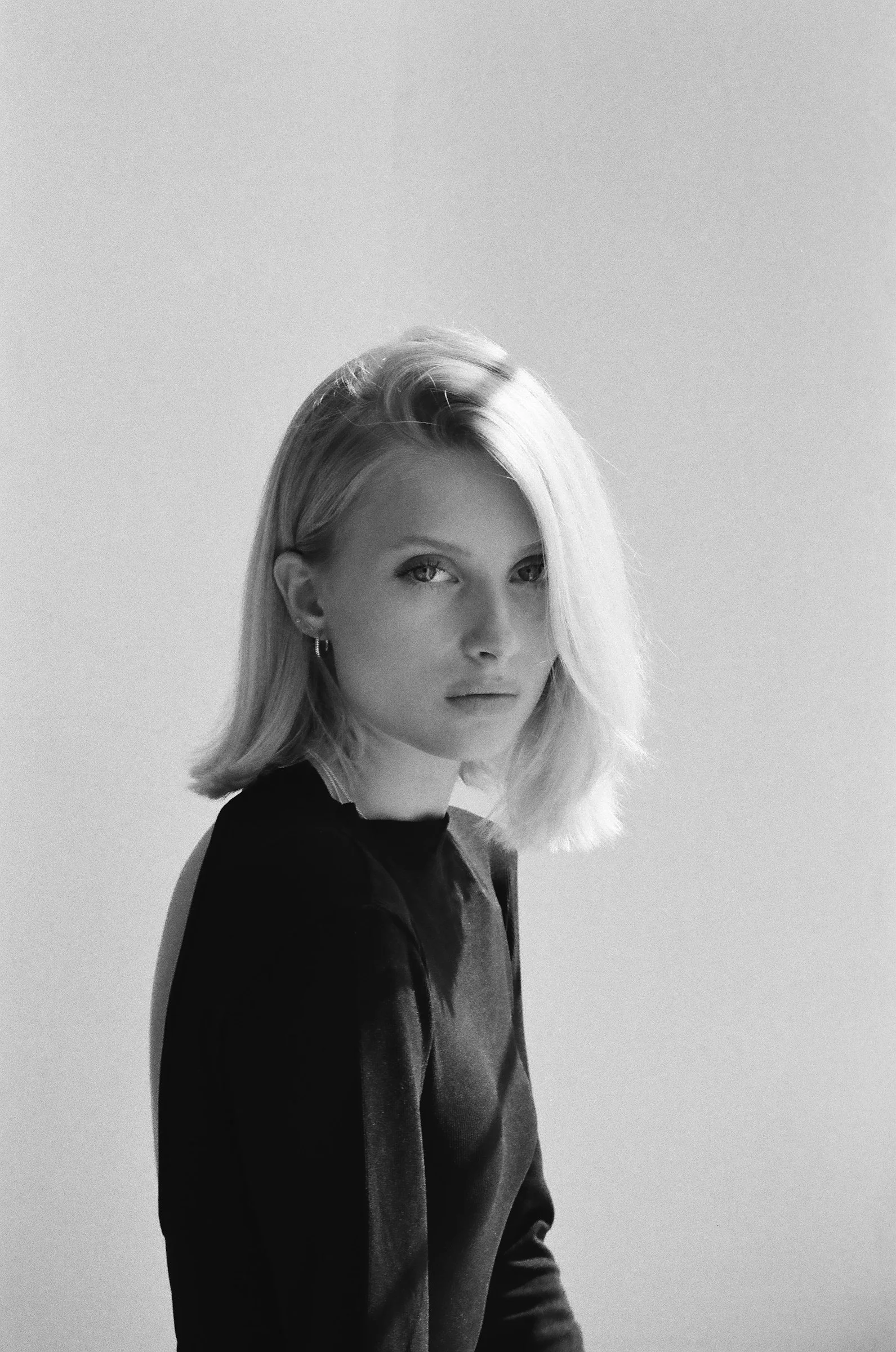 Blonde woman looking forward in black and white