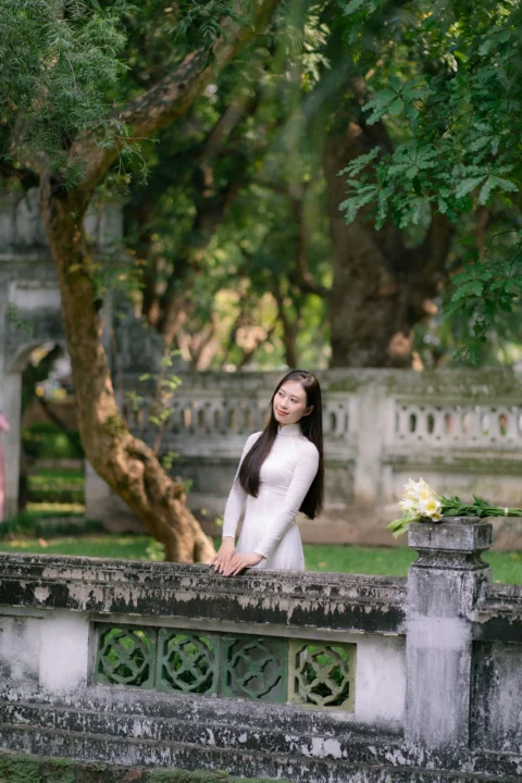 A woman poses in a garden