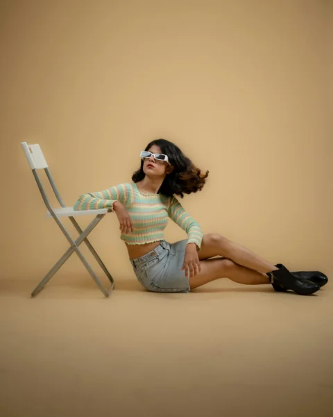 a woman sitting on a chair with her legs crossed