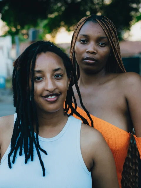 Two women posing together outdoors
