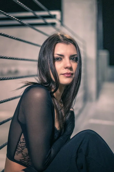 a woman sitting on the ground with her legs crossed