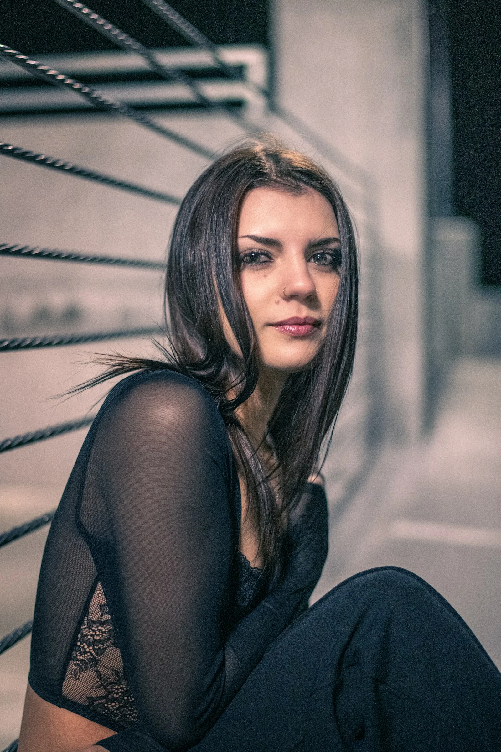 a woman sitting on the ground with her legs crossed