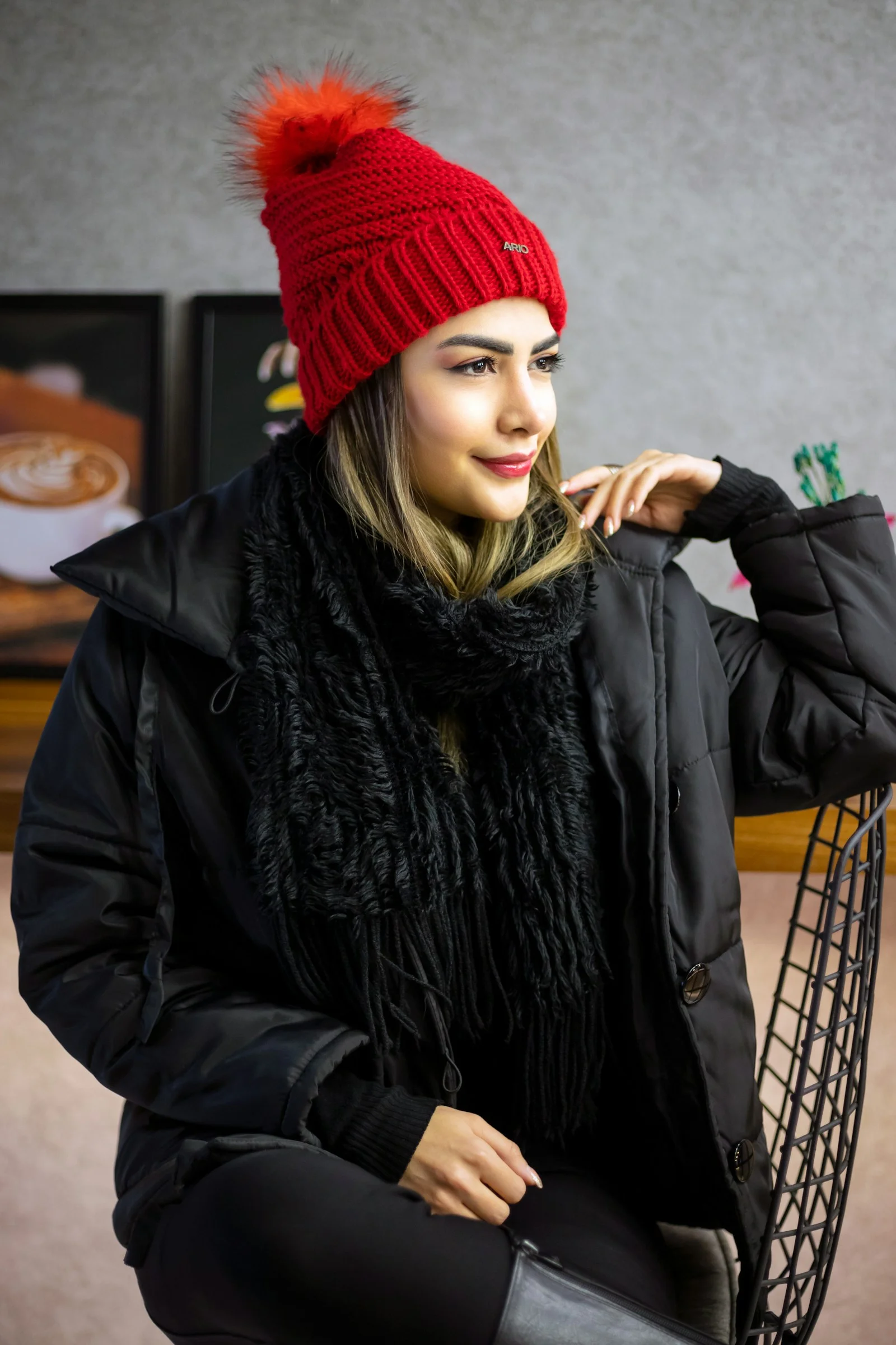Woman in red hat and black coat