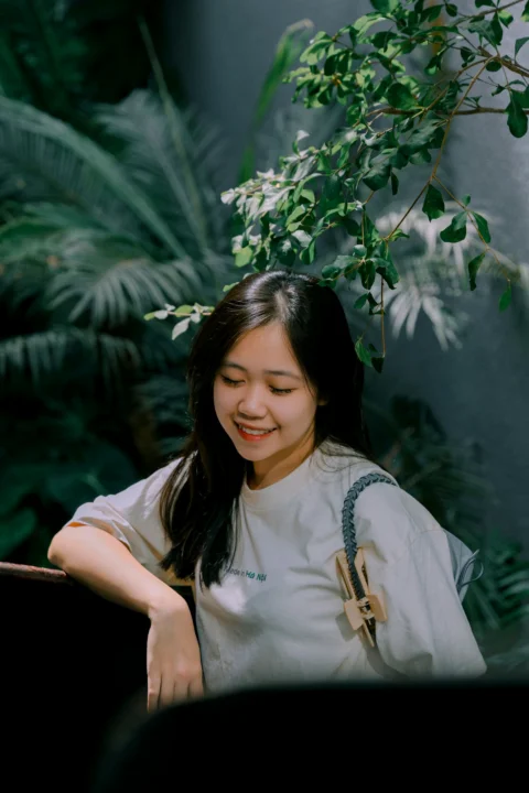 A woman sitting in front of a piano smiling