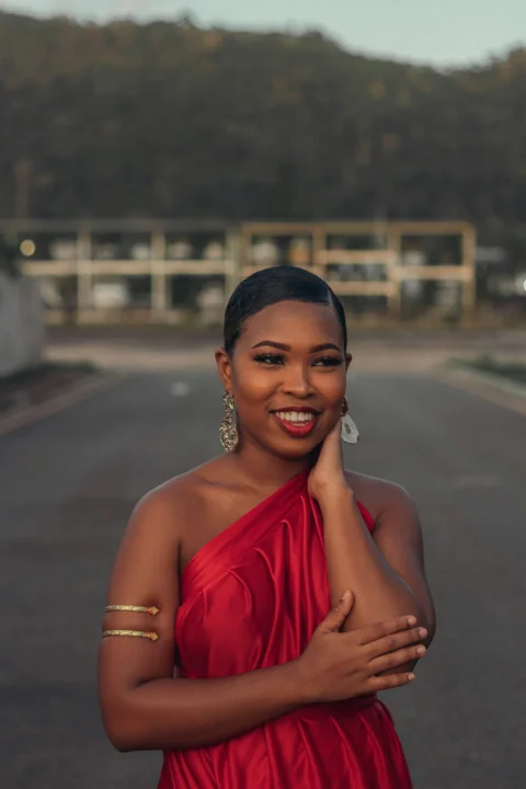 a woman in a red dress posing for a picture