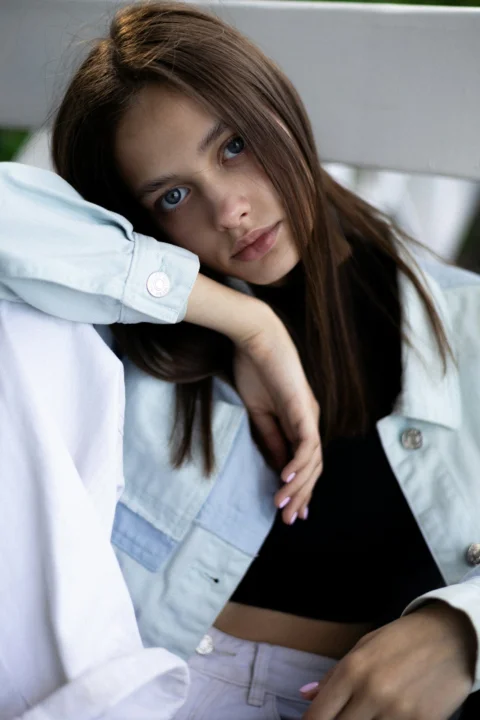 A young woman poses with a thoughtful expression